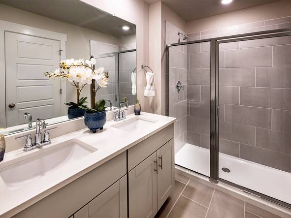 The primary bath offers a large walk-in shower. Photography from Townes at Garrison Grove.