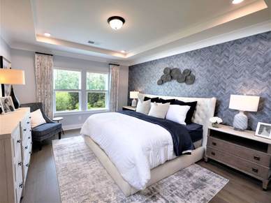 The primary suite offers a private retreat, featuring a luxurious bathroom and walk-in closet.