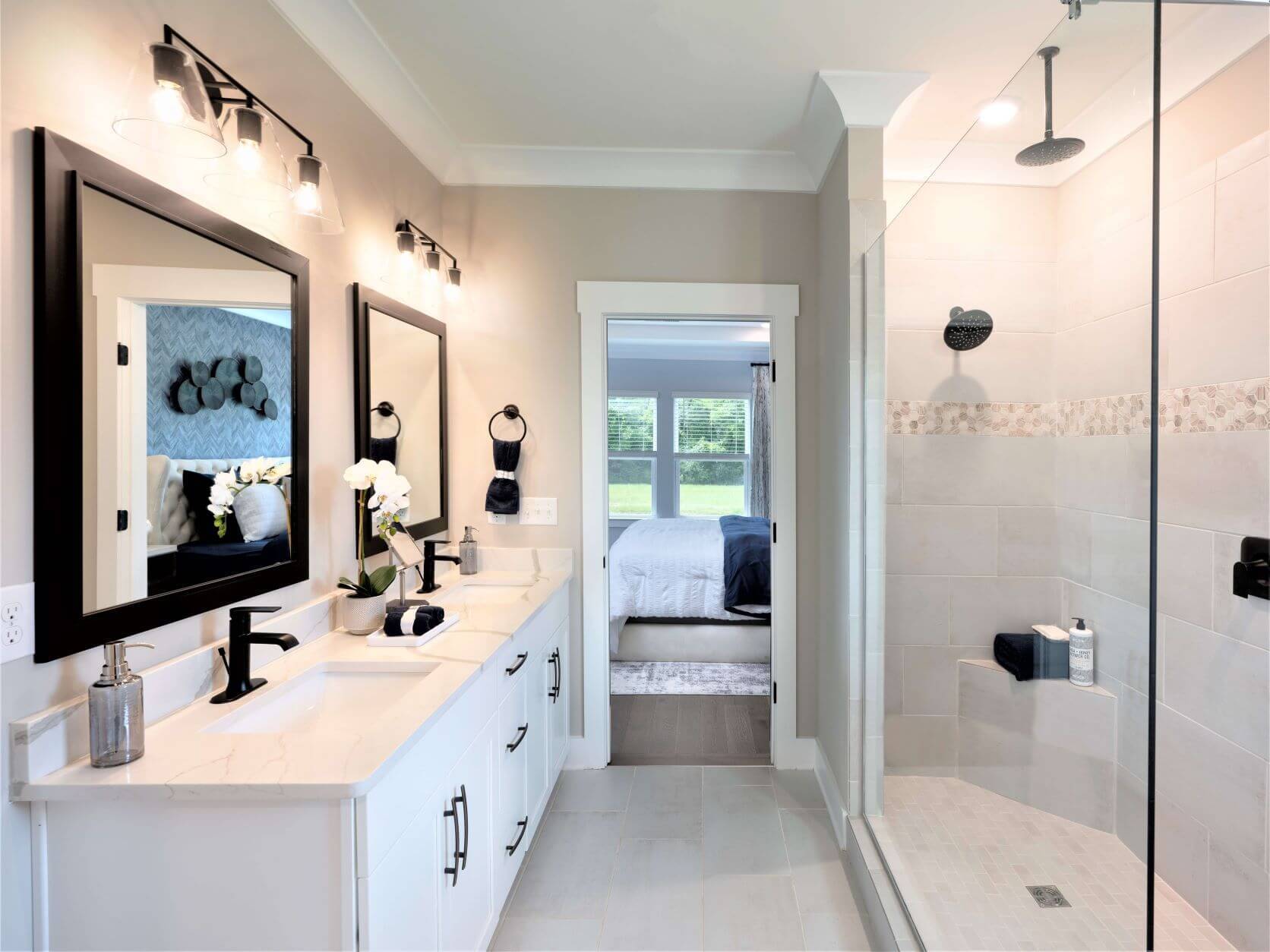 The luxurious primary bath features dual vanity sinks and a walk-in shower.
