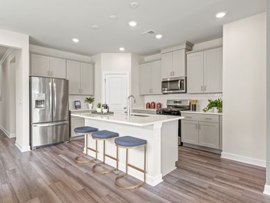 The well-appointed kitchen features a large island to make meal prep a breeze.