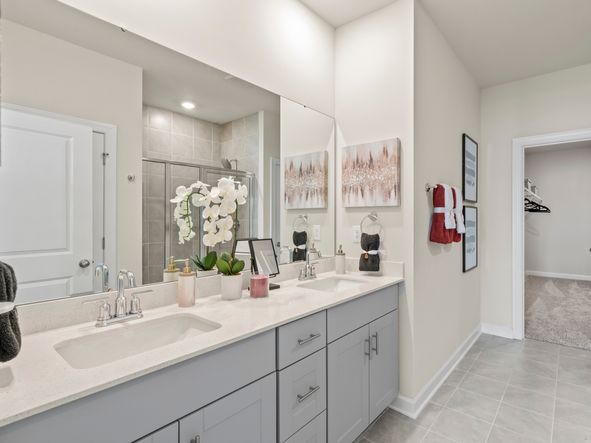 The primary ensuite boasts duel sinks, tile shower and large walk-in closet.
