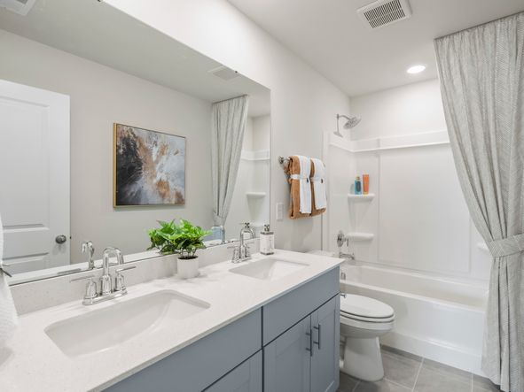 The secondary bathroom offers dual sinks and plenty of space for family and guests.