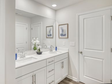 Dual vanities and a spacious walk-in closet outfit the ensuite bath.