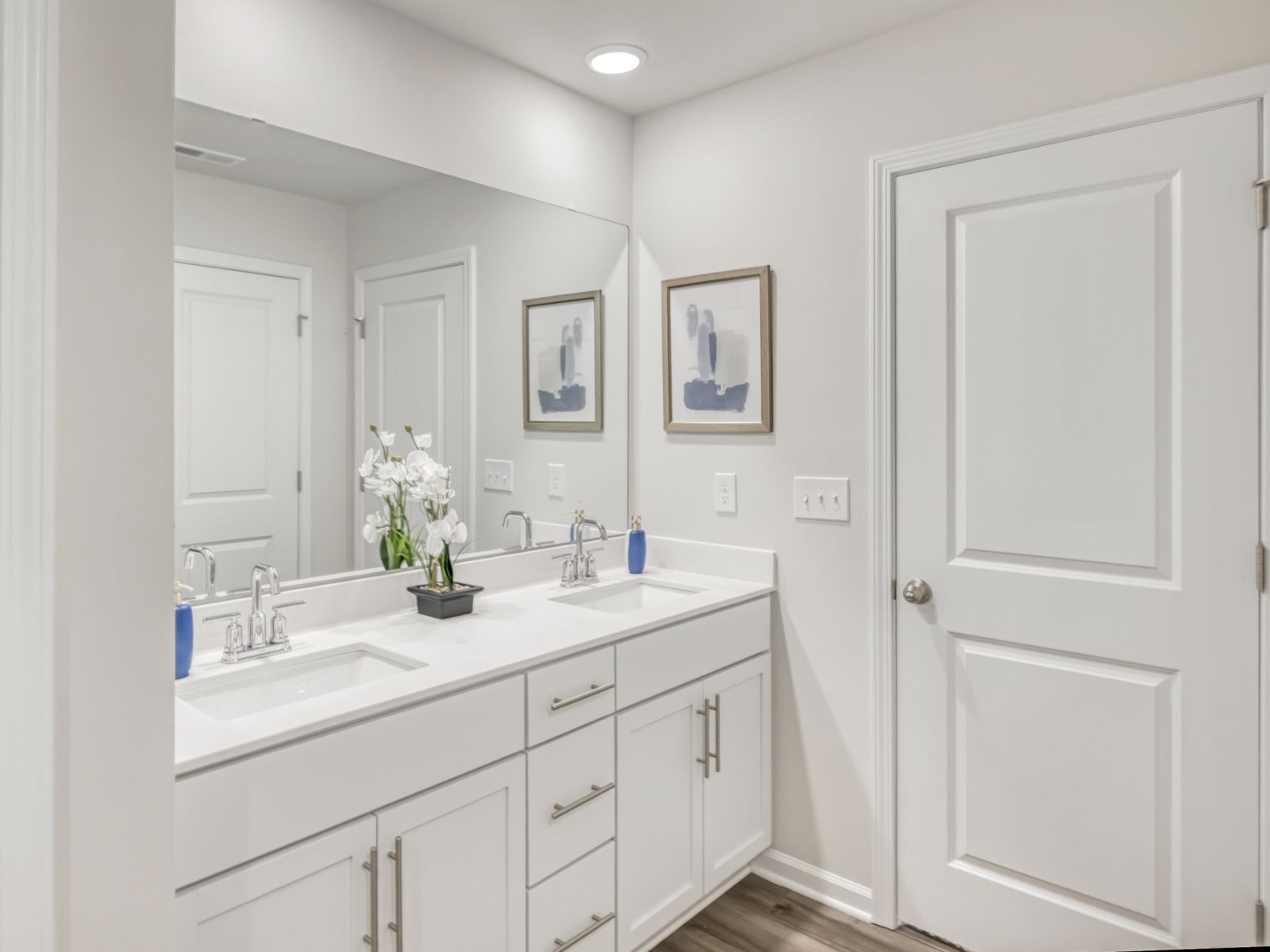 Dual vanities and a spacious walk-in closet outfit the ensuite bath.