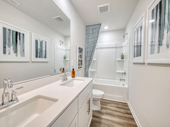Dual vanities outfit the upstairs secondary bathroom.