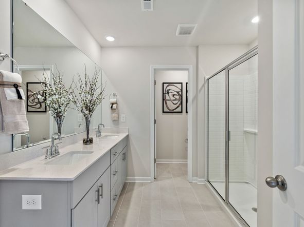 The primary bathroom connects to your primary suite with dual sinks and a walk-in closet.