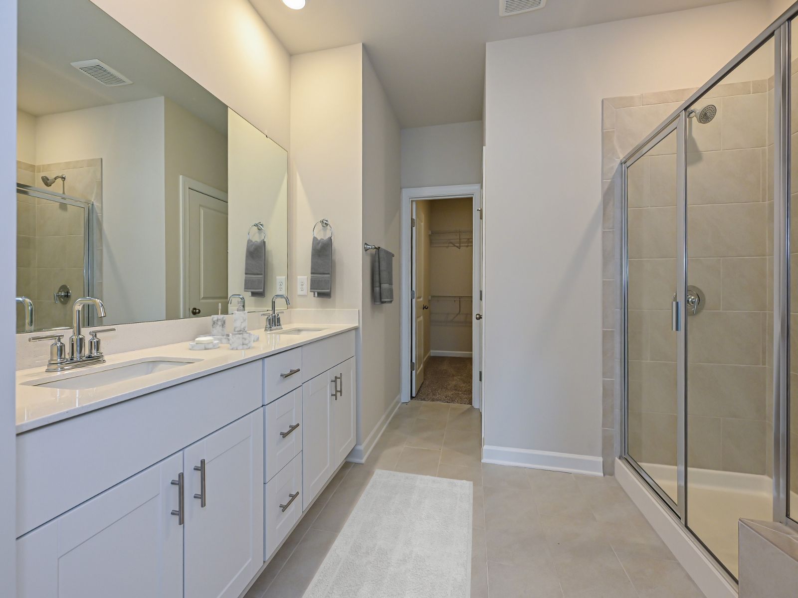 The primary bathroom features a double-sink vanity and an oversized closet.