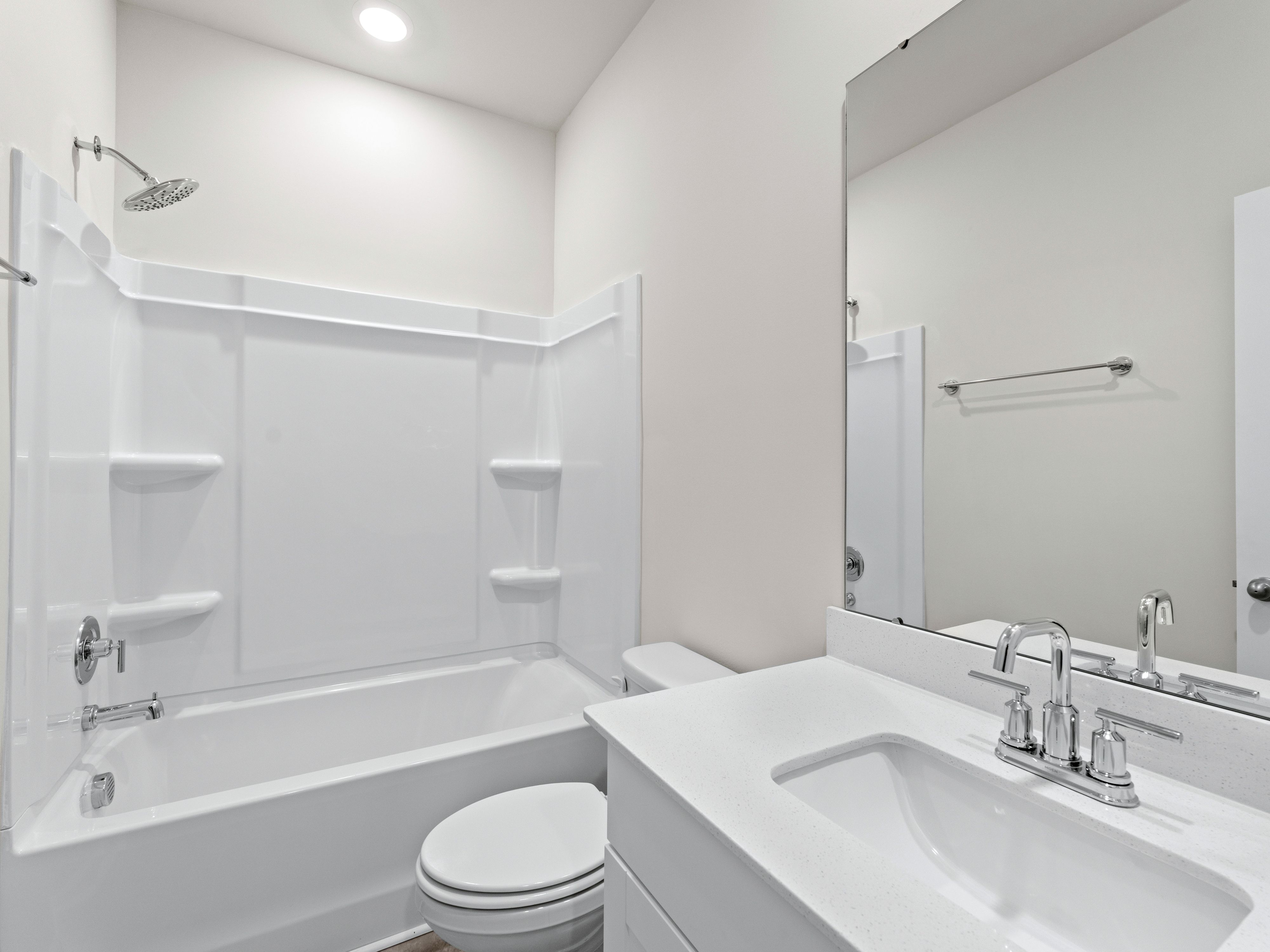 The second bathroom complete with a spacious vanity and bathtub.