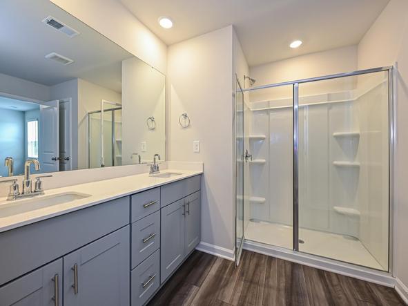 The secondary bathroom boasts dual-sinks and a walk-in shower.