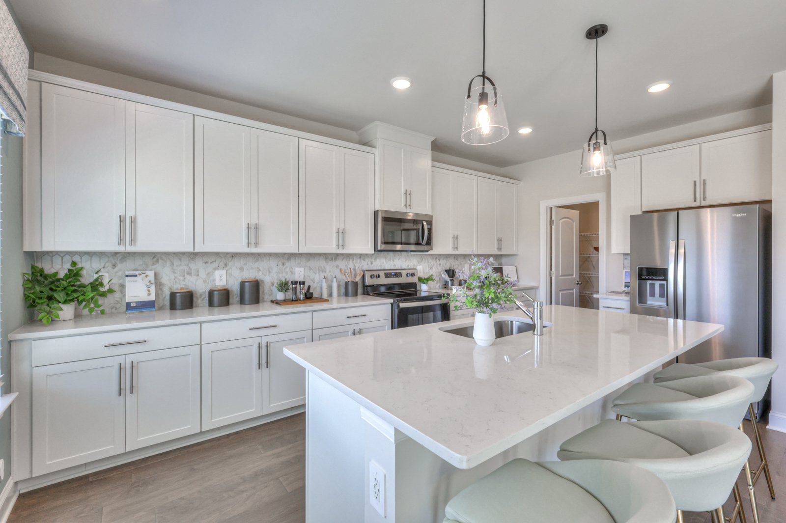Designer-curated finishes, including quartz countertops, create an elegant feel.