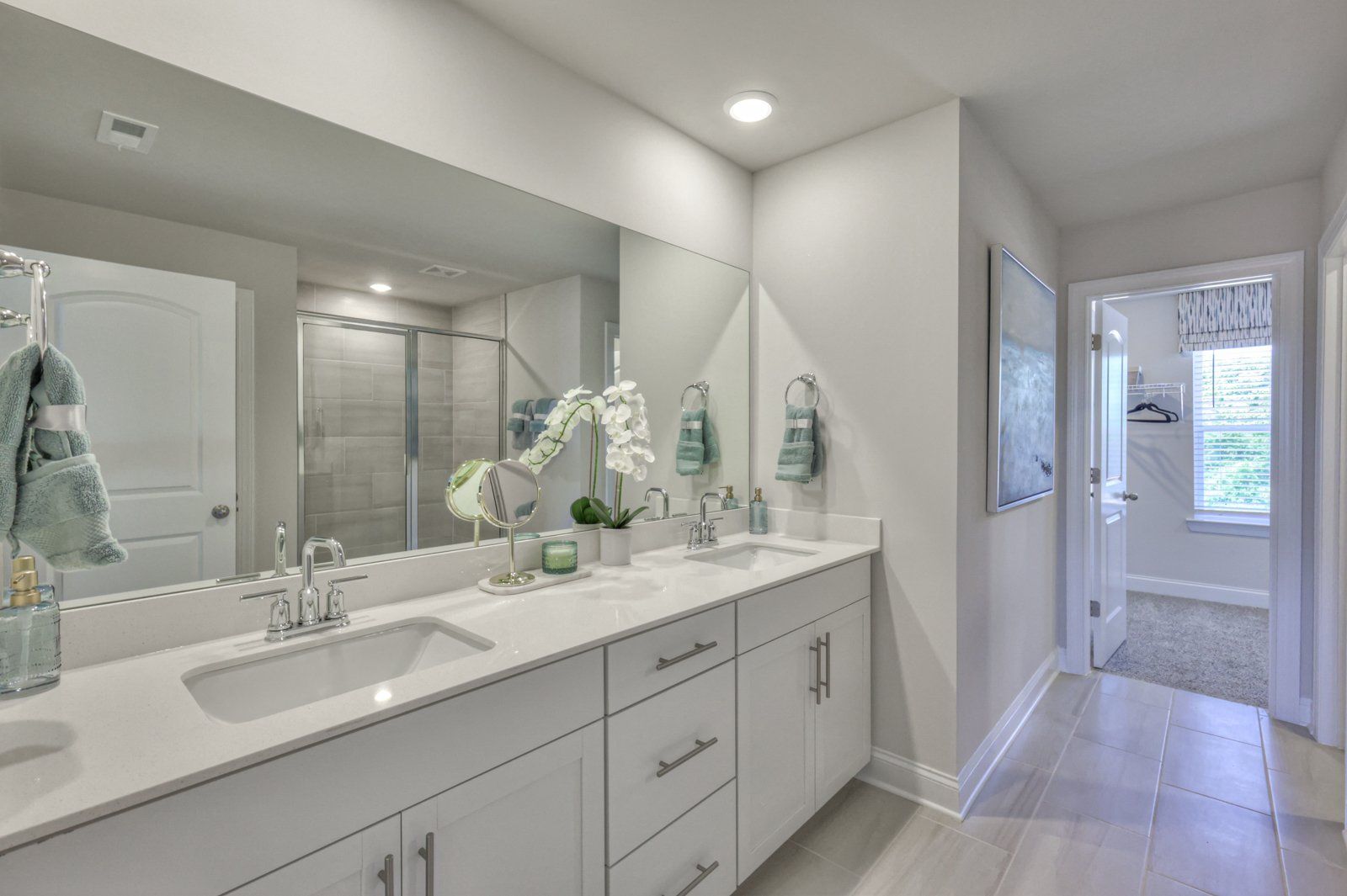 The primary bathroom includes dual-vanity sinks and a walk-in closet.