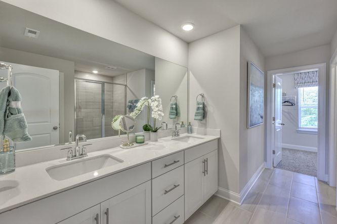 The primary bathroom includes dual-vanity sinks and a walk-in closet.