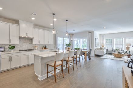 Designer-curated finishes, including quartz countertops, create an elegant feel.