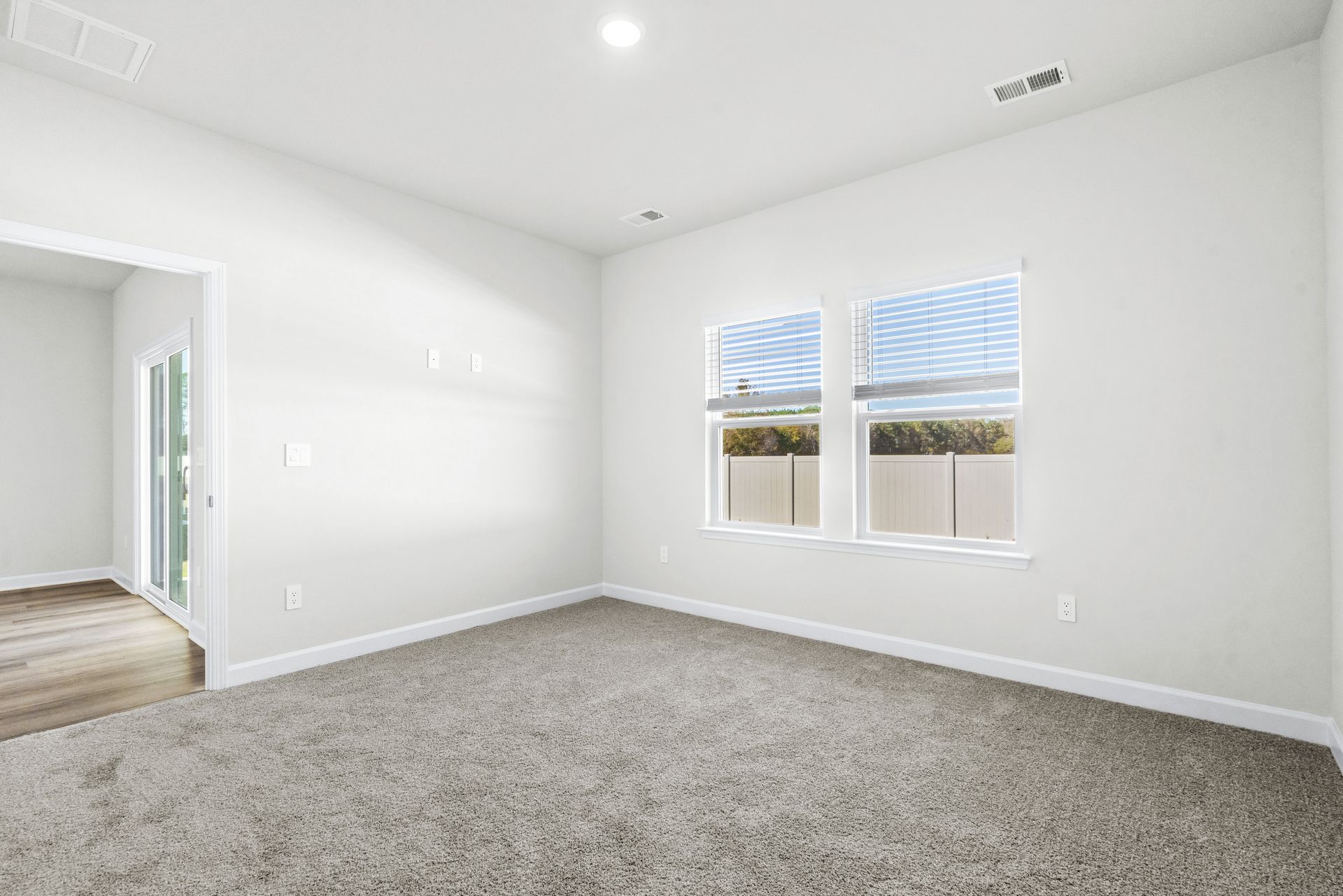 Relax and recharge in the spacious, light-filled primary suite.