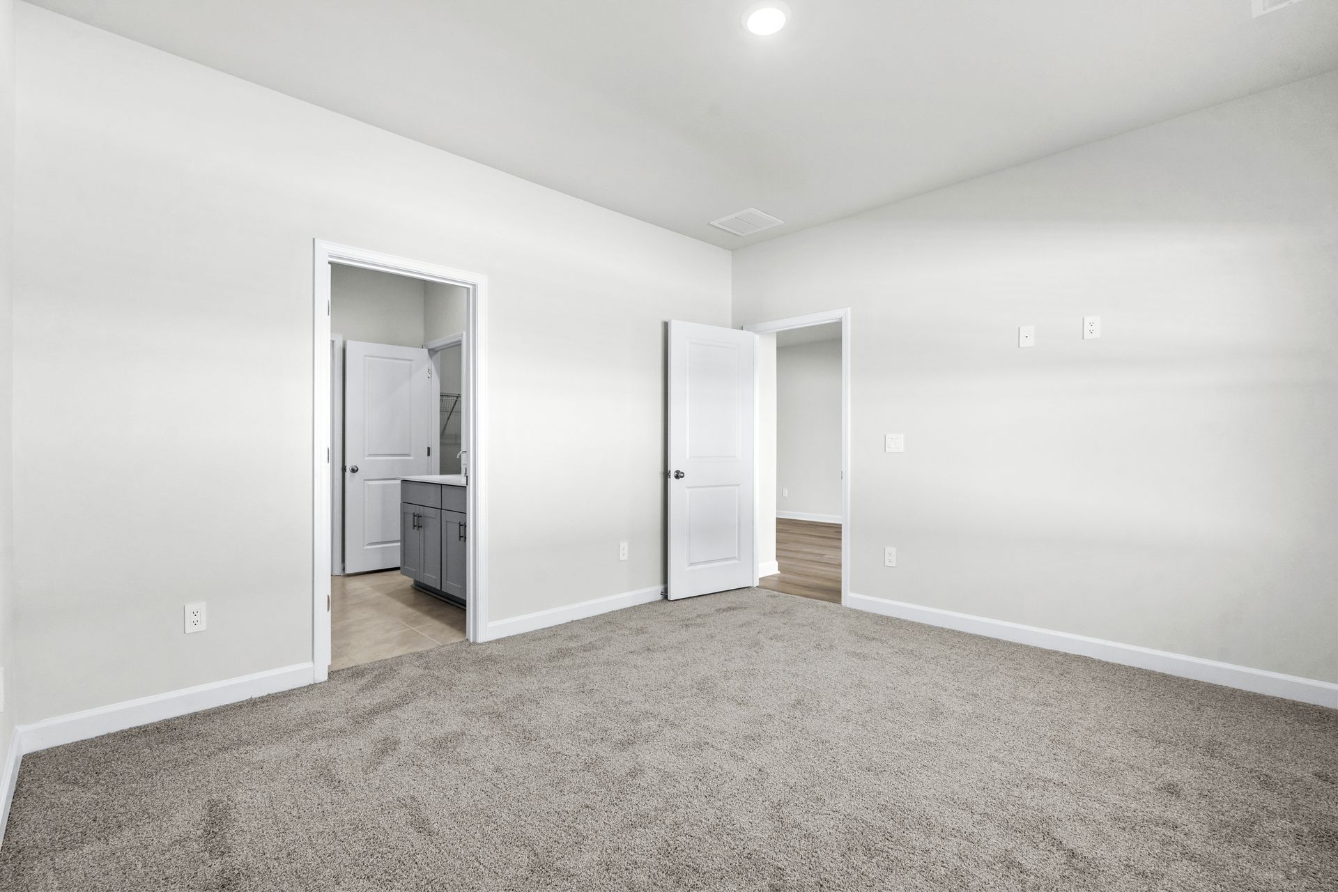 The primary suite leads to a well-appointed private bathroom.