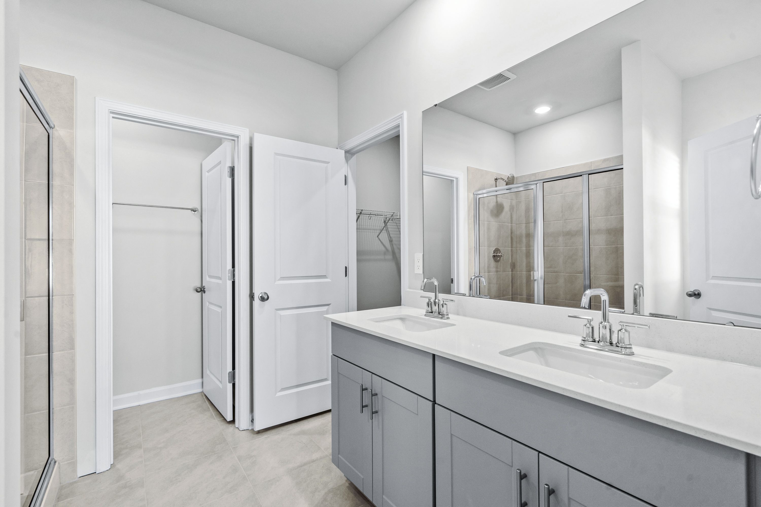 The primary ensuite boasts duel sinks, tile shower and large walk-in closet.