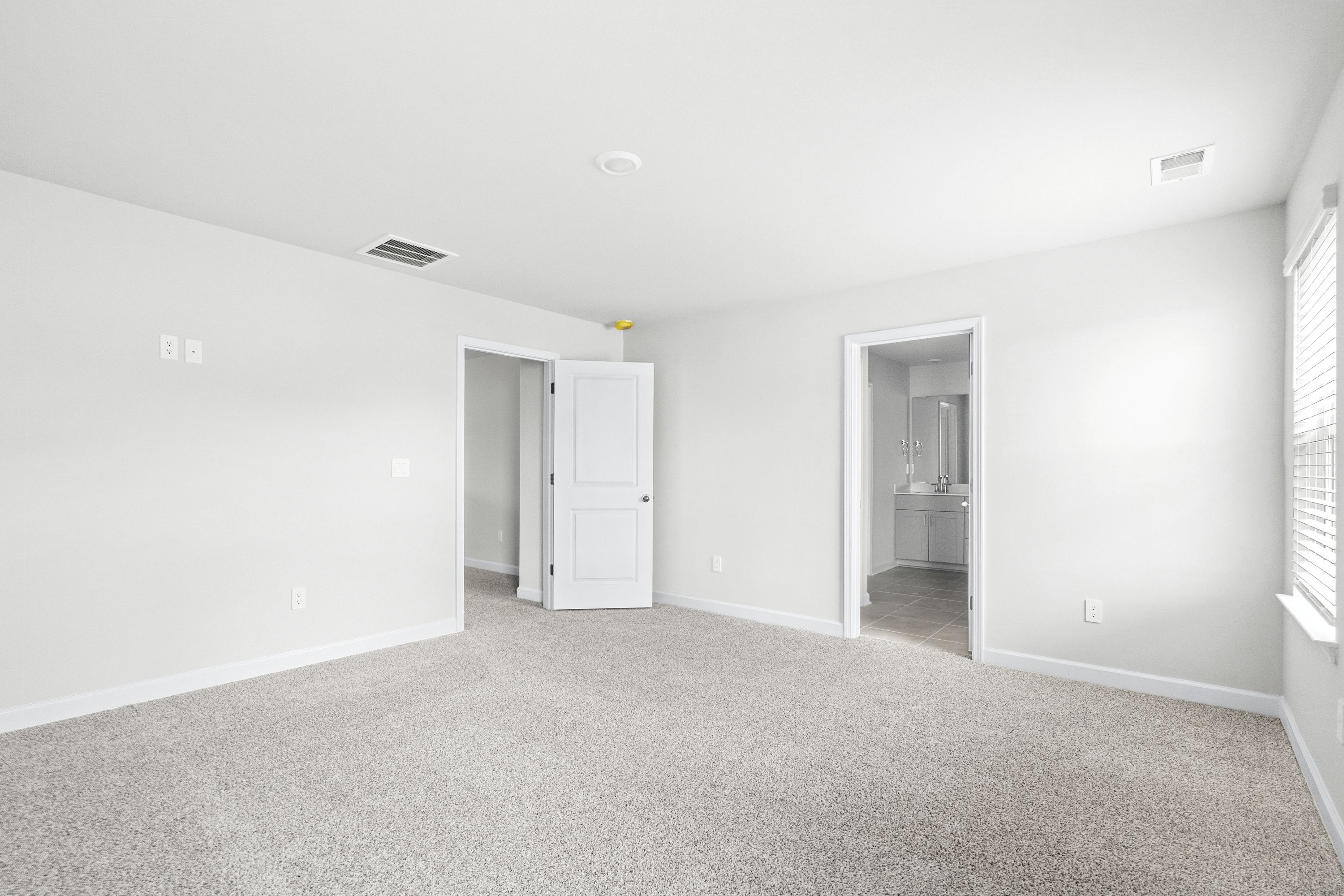 The primary suite leads to a well-appointed private bathroom.