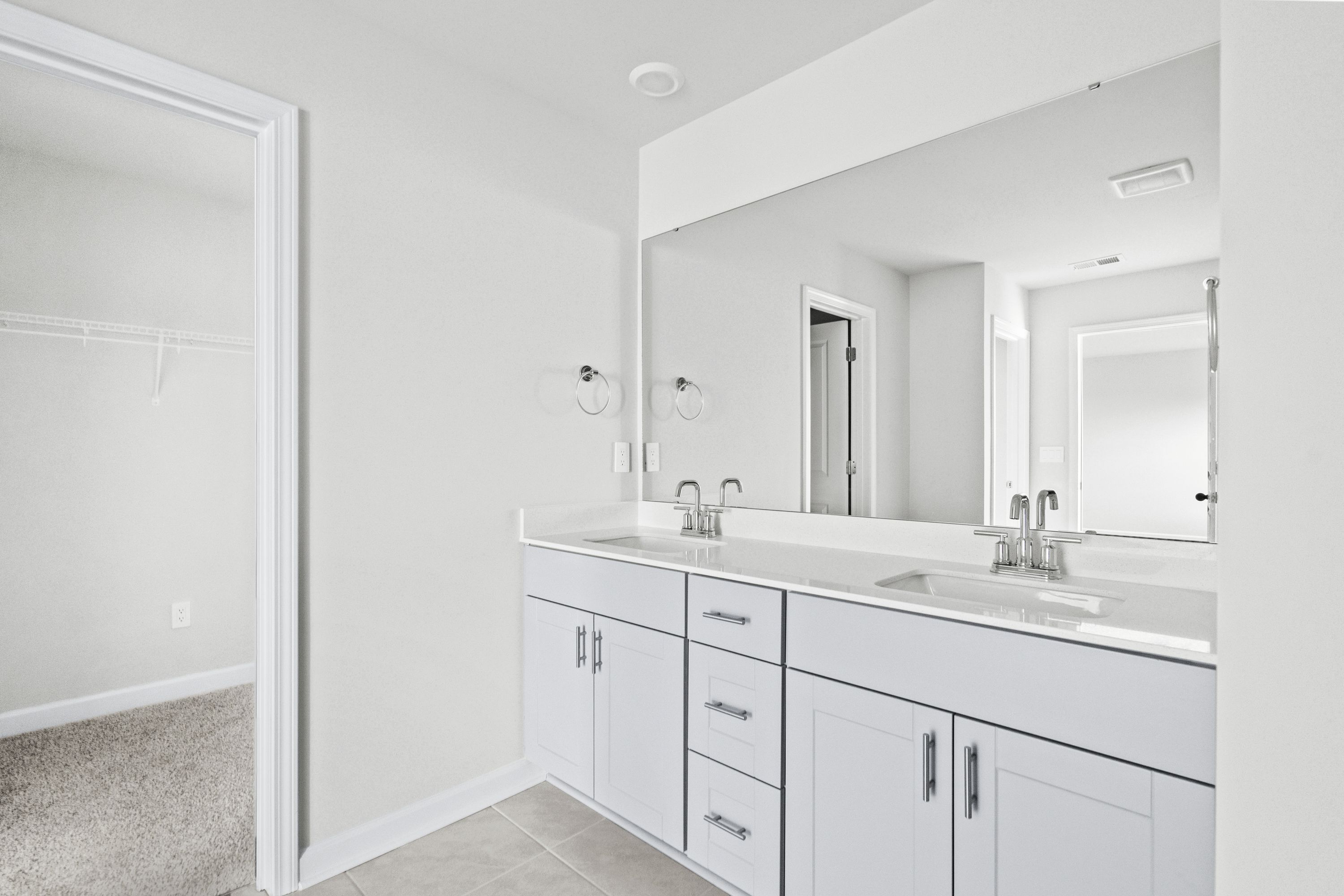 The primary ensuite boasts duel sinks, tile shower and large walk-in closet.