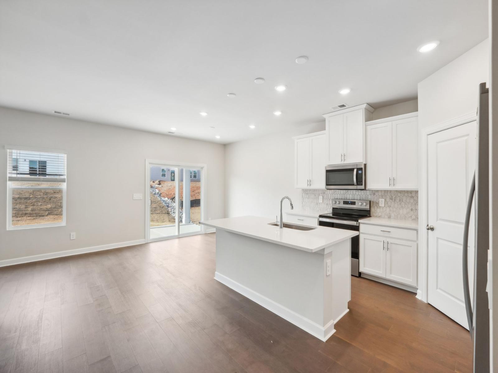 Your new kitchen with an oversized island and countless storage cabinets.