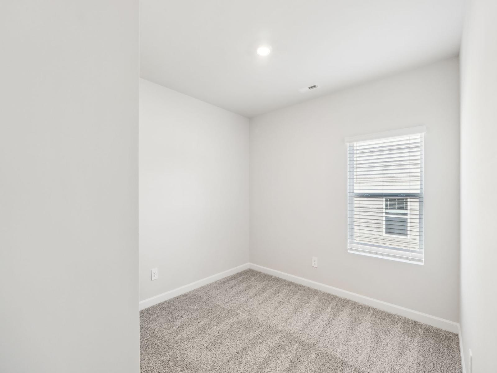 This customizable secondary bedroom is a peaceful space to unwind.