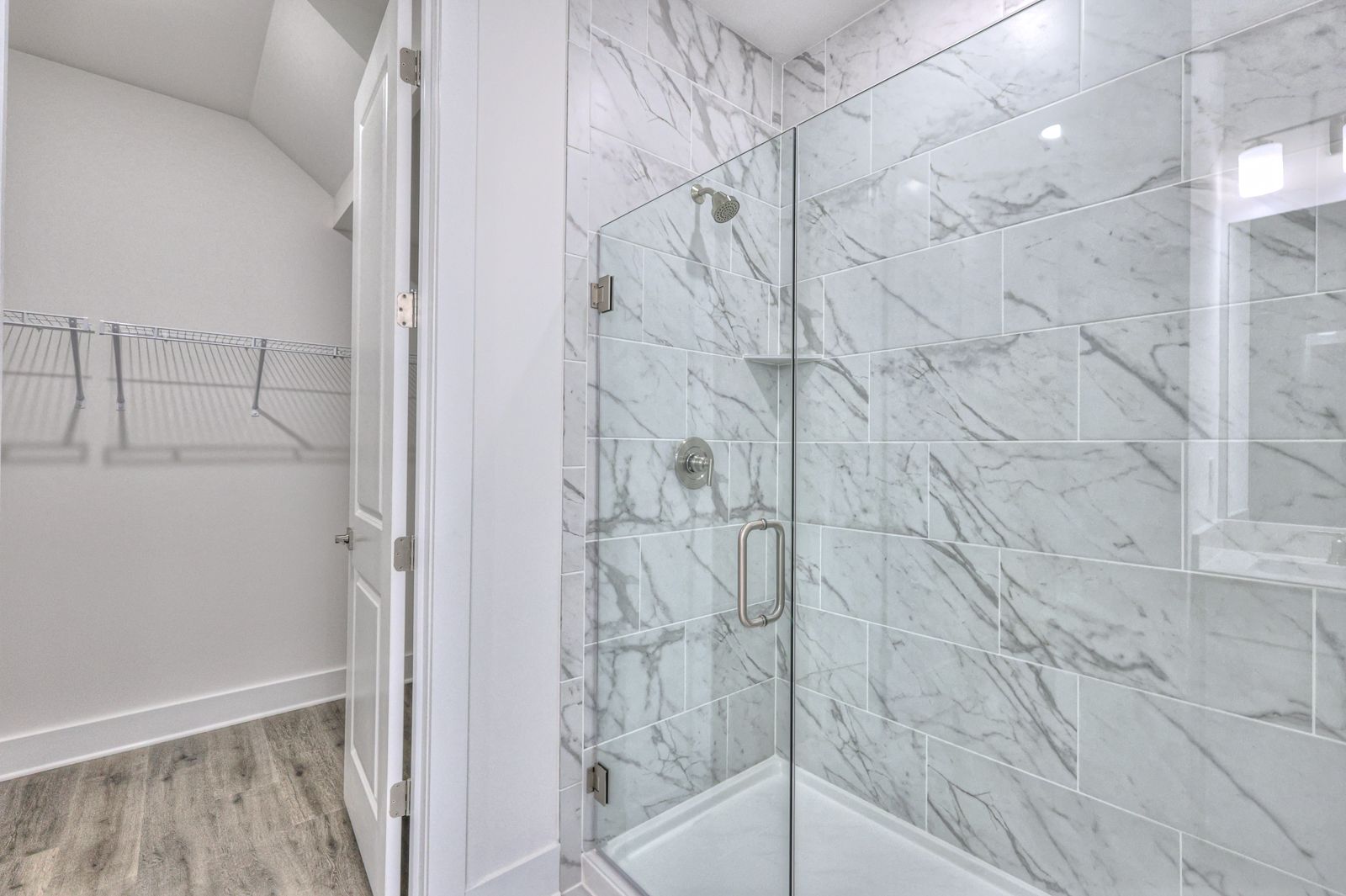 The primary bathroom offers dual vanity sinks and a walk-in shower.
