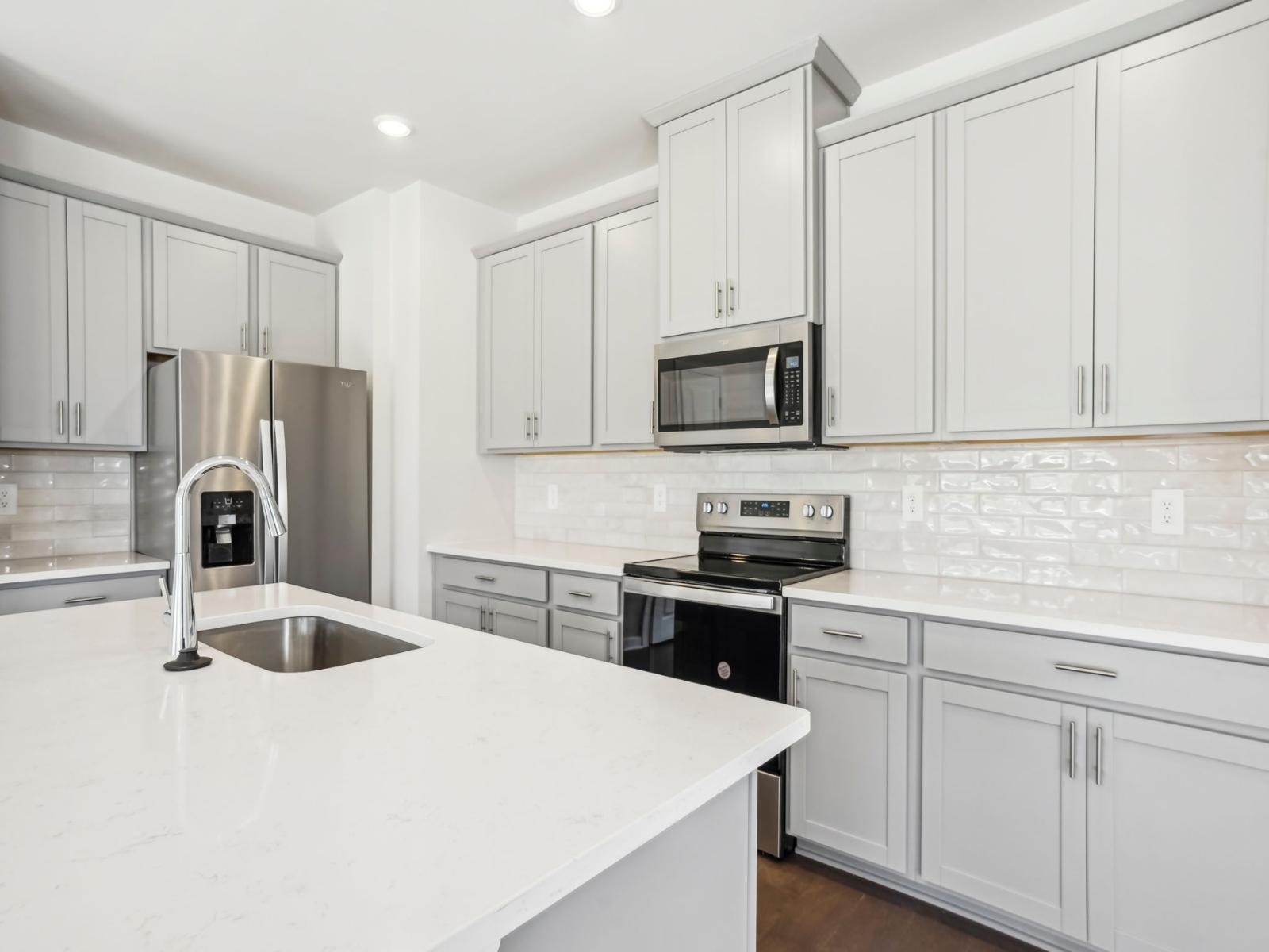Cook your favorite meal in your modern kitchen with oversized counters and cabinets.