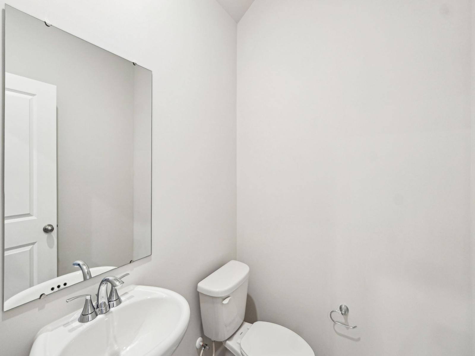 The half bathroom is conveniently located for guests and other visitors.