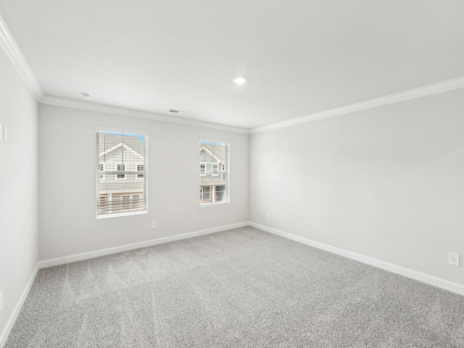 Enjoy rest and relaxation in the spacious primary bedroom.