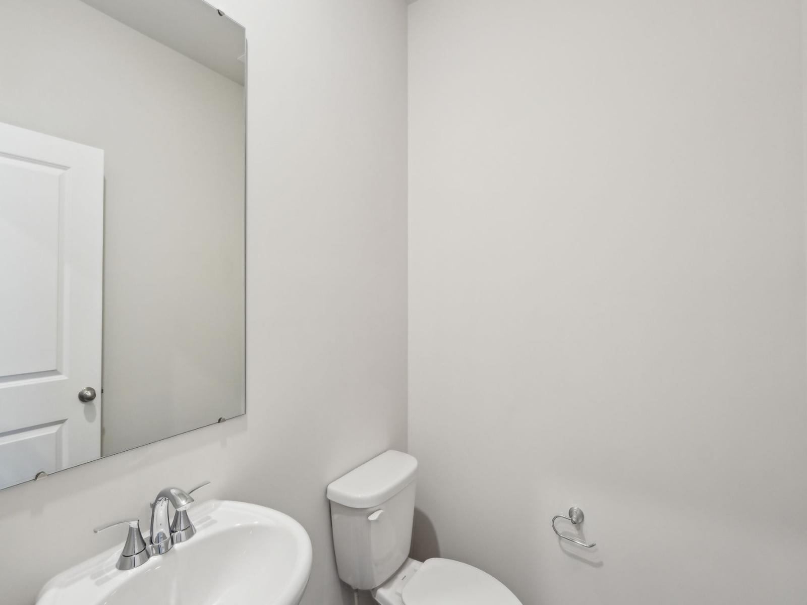 The half bathroom is conveniently located for guests and visitors.