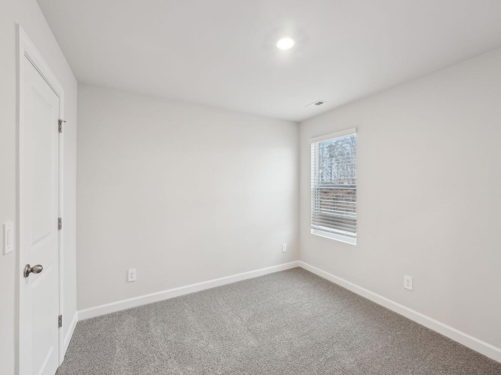 The secondary bedroom is the perfect size for a home gym or lounge space.
