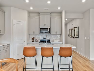 The gourmet kitchen is fitted with a walk-in pantry and designer finishes.