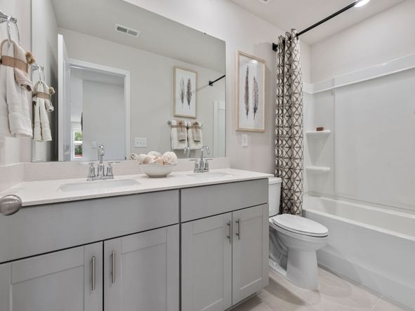 The secondary bathroom boasts dual sinks making early mornings a breeze.