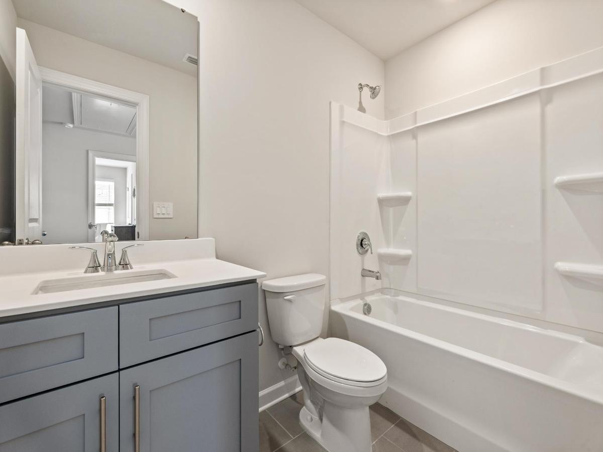 The secondary bath offers a space for guests to get ready.
