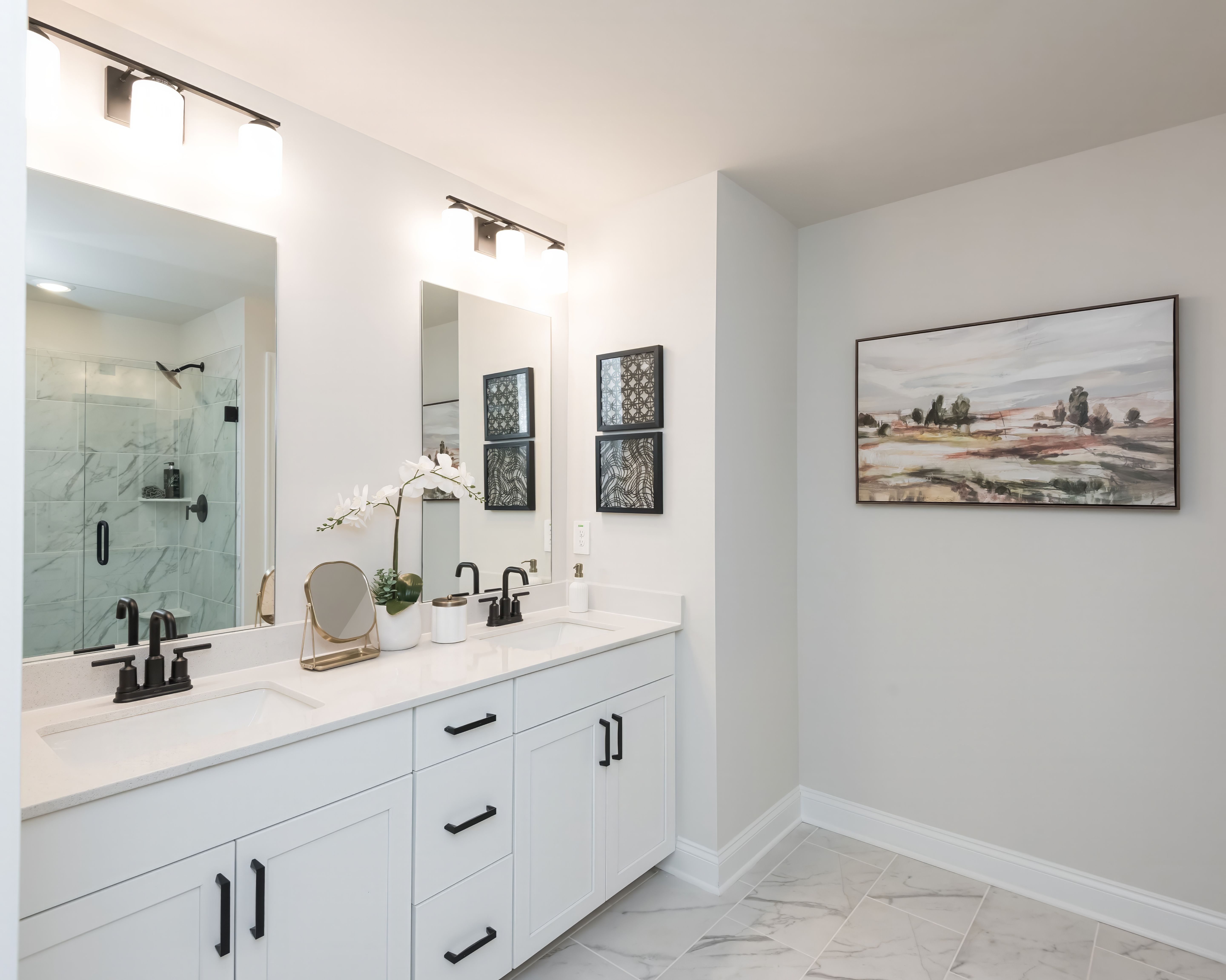 The ensuite bathroom features dual-vanity sinks and a walk-in closet.