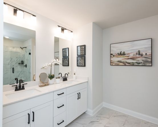 The ensuite bathroom features dual-vanity sinks and a walk-in closet.