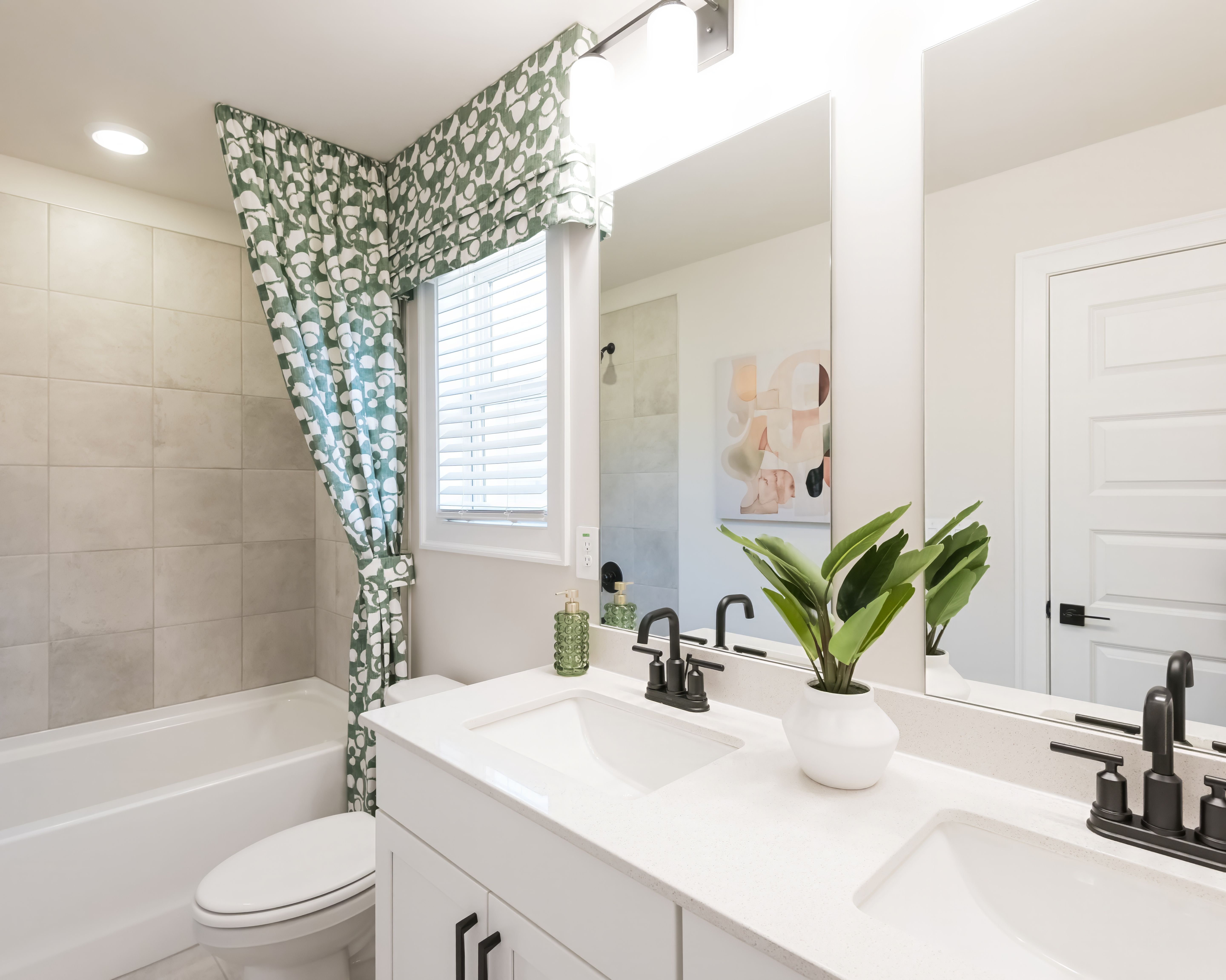 Getting ready in the morning is a breeze in this spacious dual-vanity bathroom.