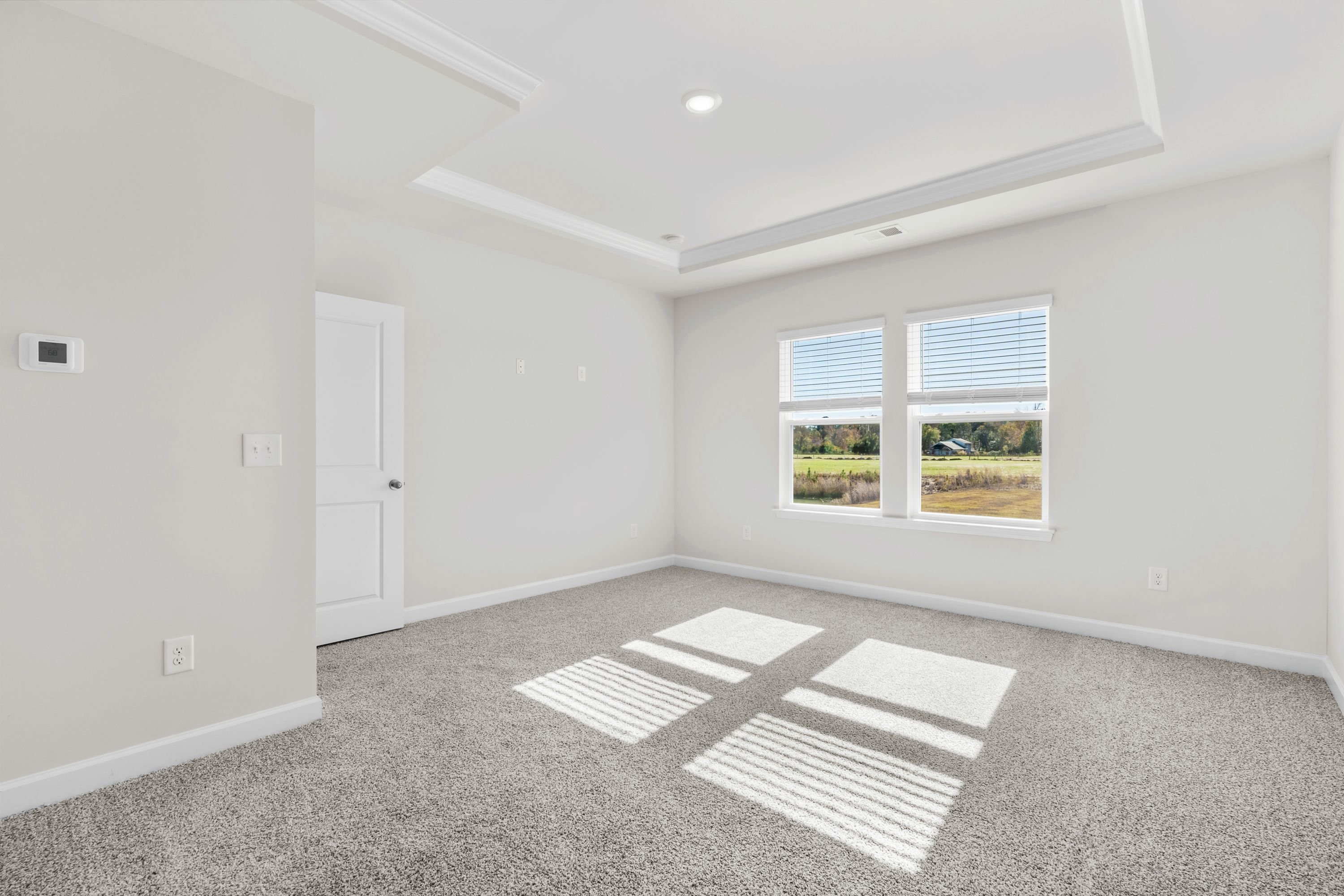 Relax and recharge in the spacious, light-filled primary suite.