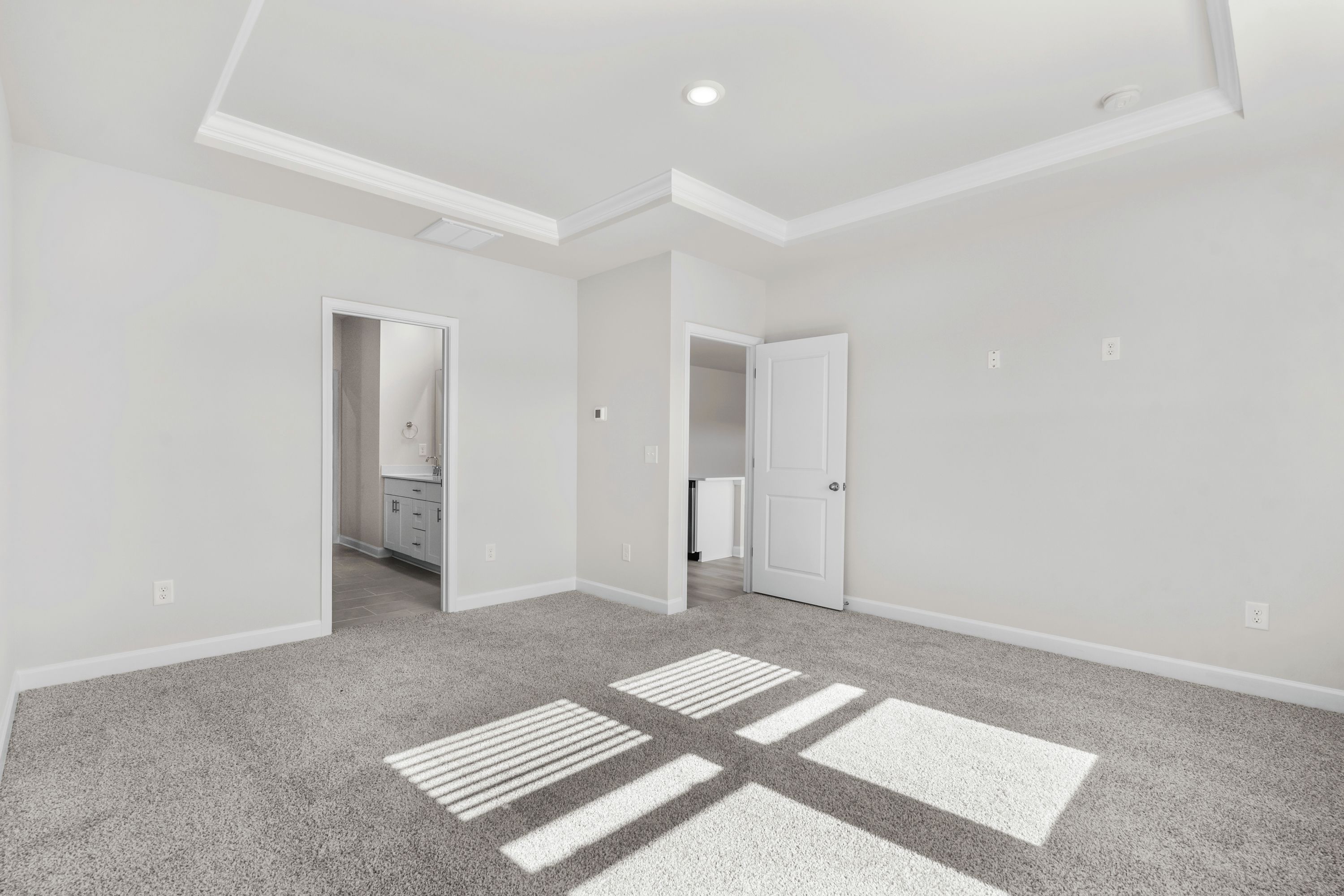 The primary suite leads to a well-appointed private bathroom.
