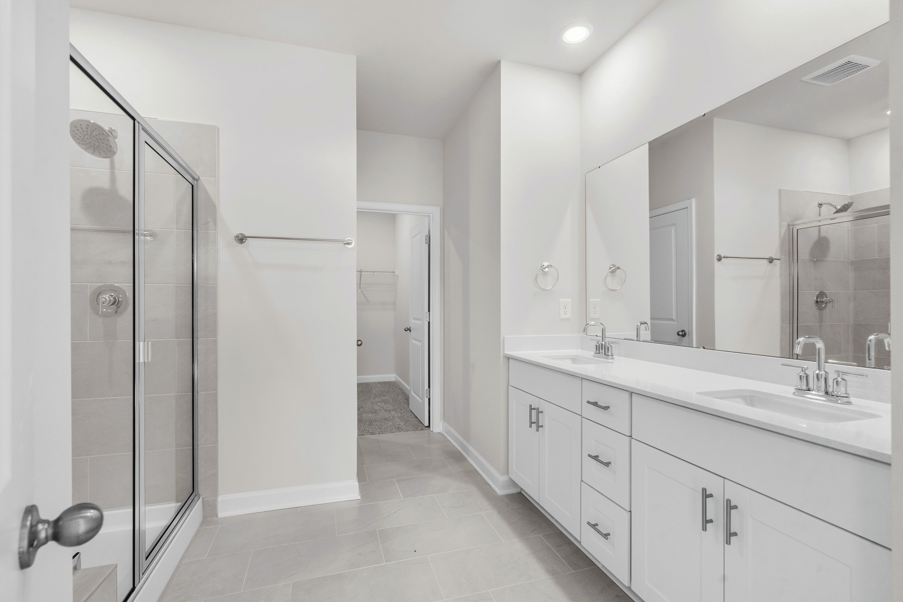 The primary ensuite boasts duel sinks, tile shower and large walk-in closet.