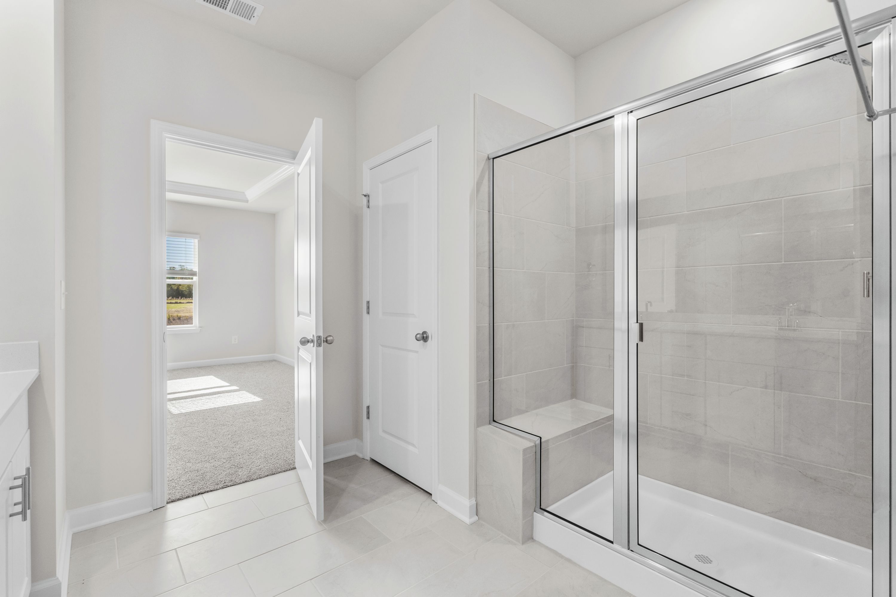 The primary ensuite boasts duel sinks, tile shower and large walk-in closet.