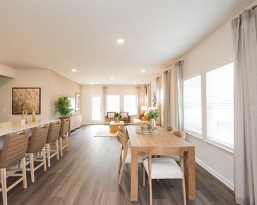 Gather the family around the dining table, at the heart of the open-concept living area.