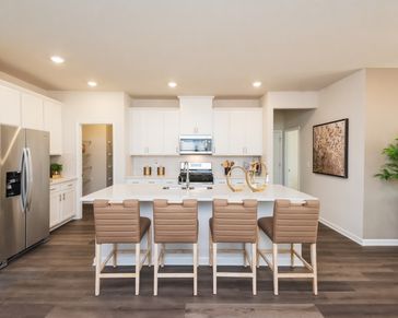 The kitchen overlooks into the dining room and living room.