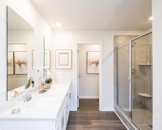 The primary bath features a walk-in shower and closed-off toilet for extra privacy.