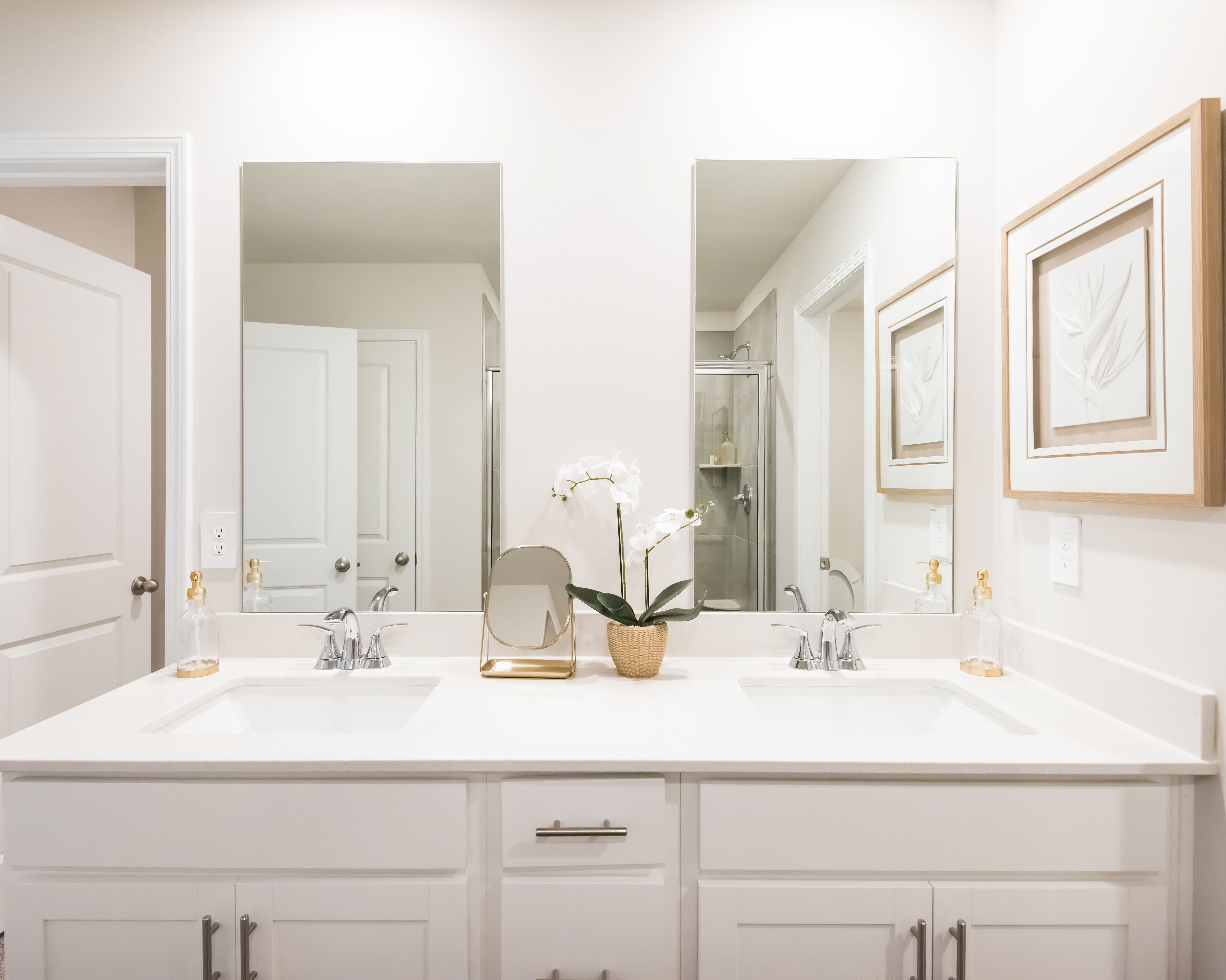 The ensuite bathroom features dual-vanity sinks and a walk-in closet.