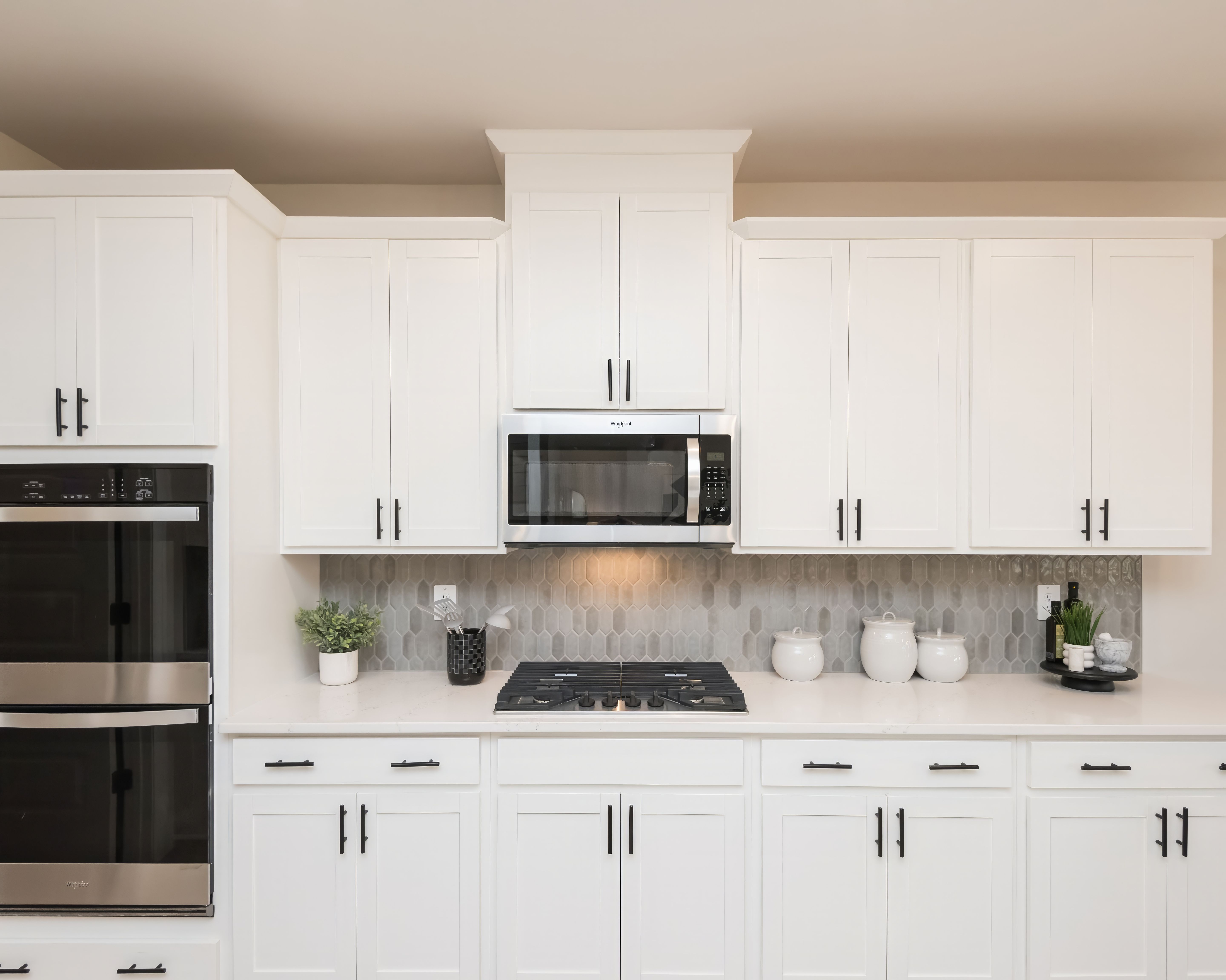 Stylish cabinets and a sleek stovetop add charm and function to your kitchen.