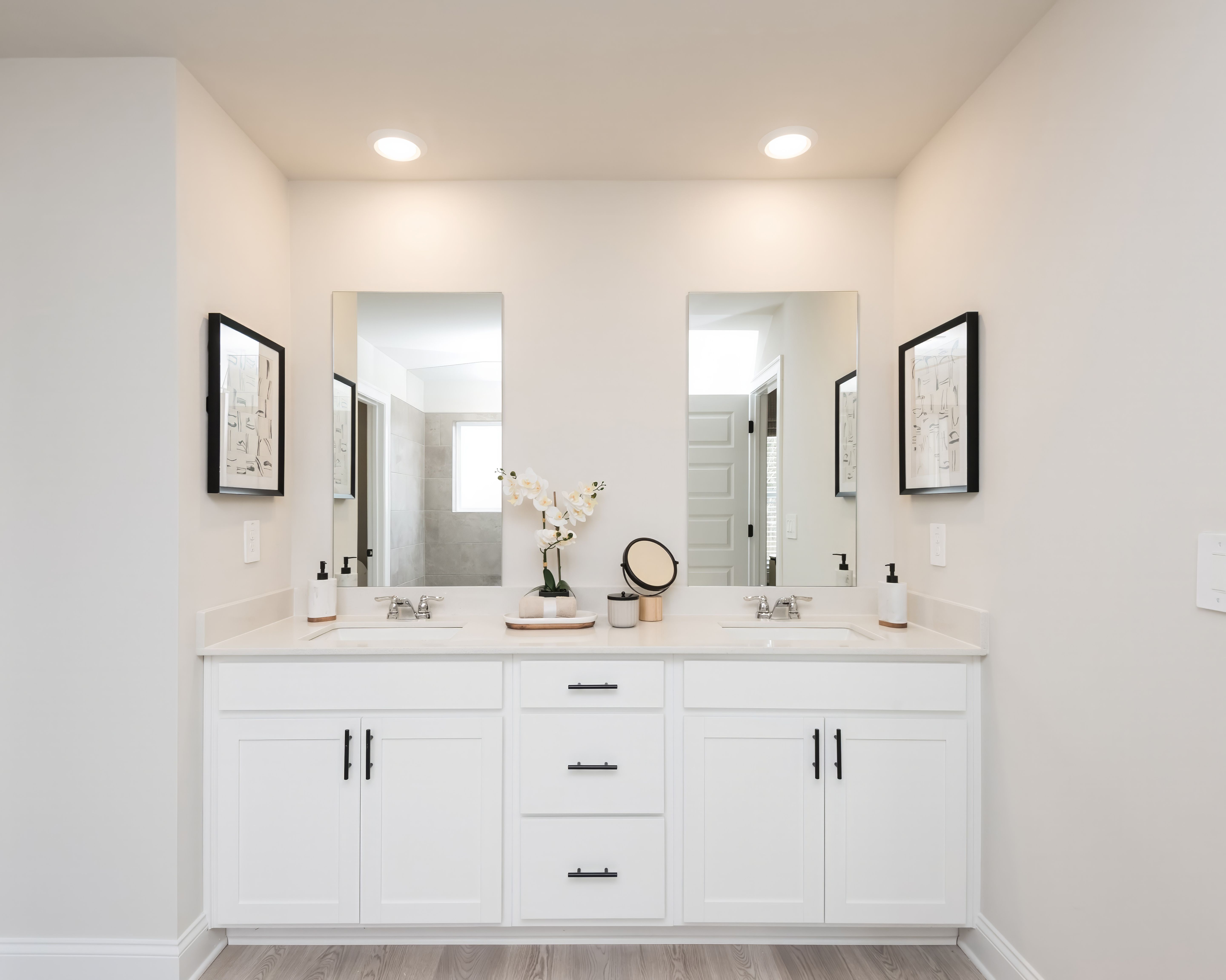 The primary bathroom features dual-vanity sinks and plenty of counter space for convenience.