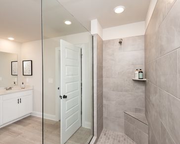Take a warm shower in the primary bath’s walk-in shower, the perfect way to unwind.