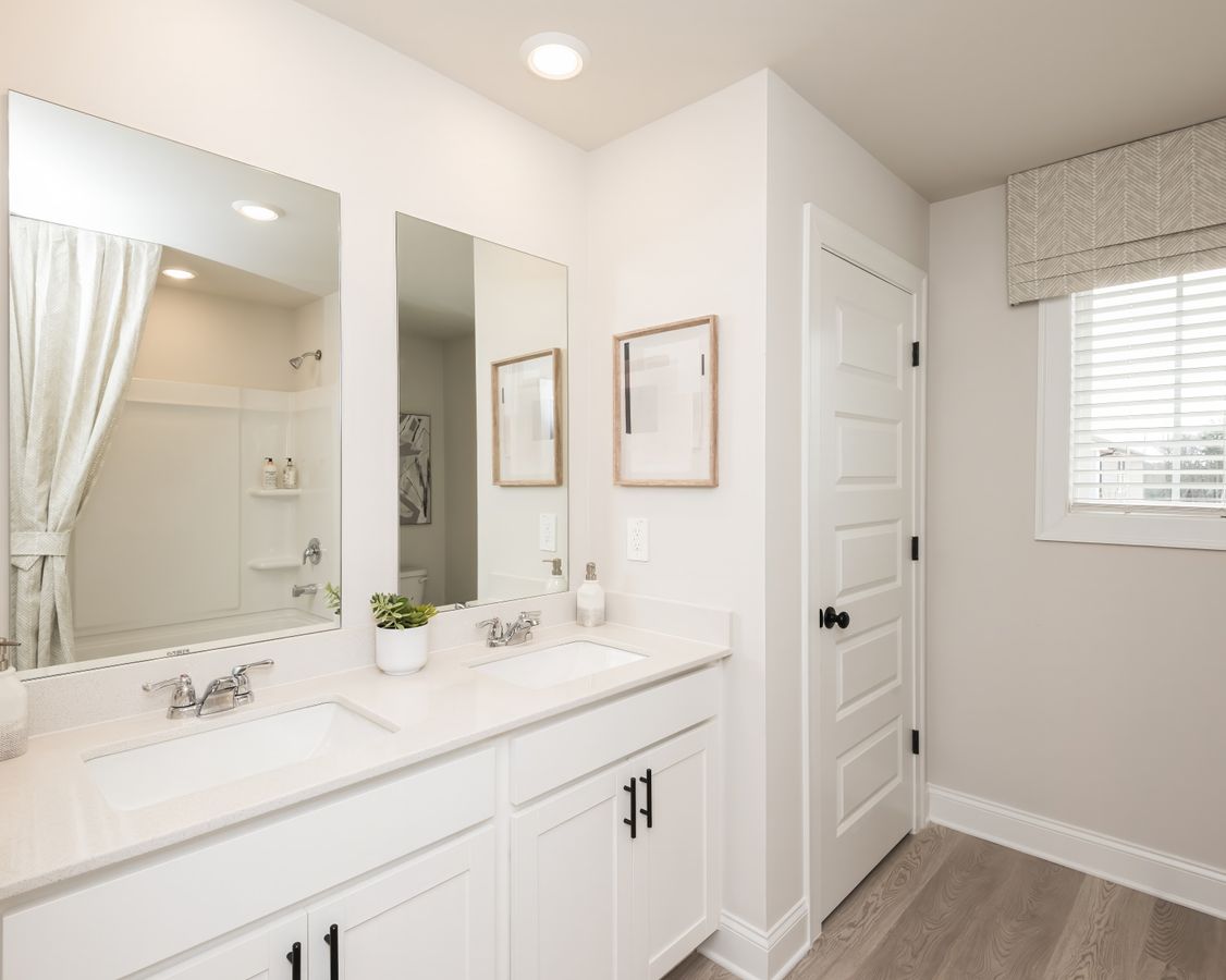 The upstairs secondary bathroom offers convenience and comfort for family or guests.