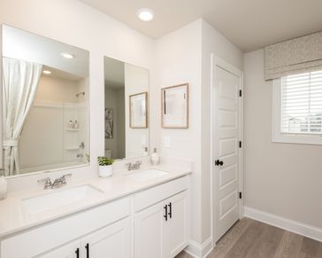 The upstairs secondary bathroom offers convenience and comfort for family or guests.