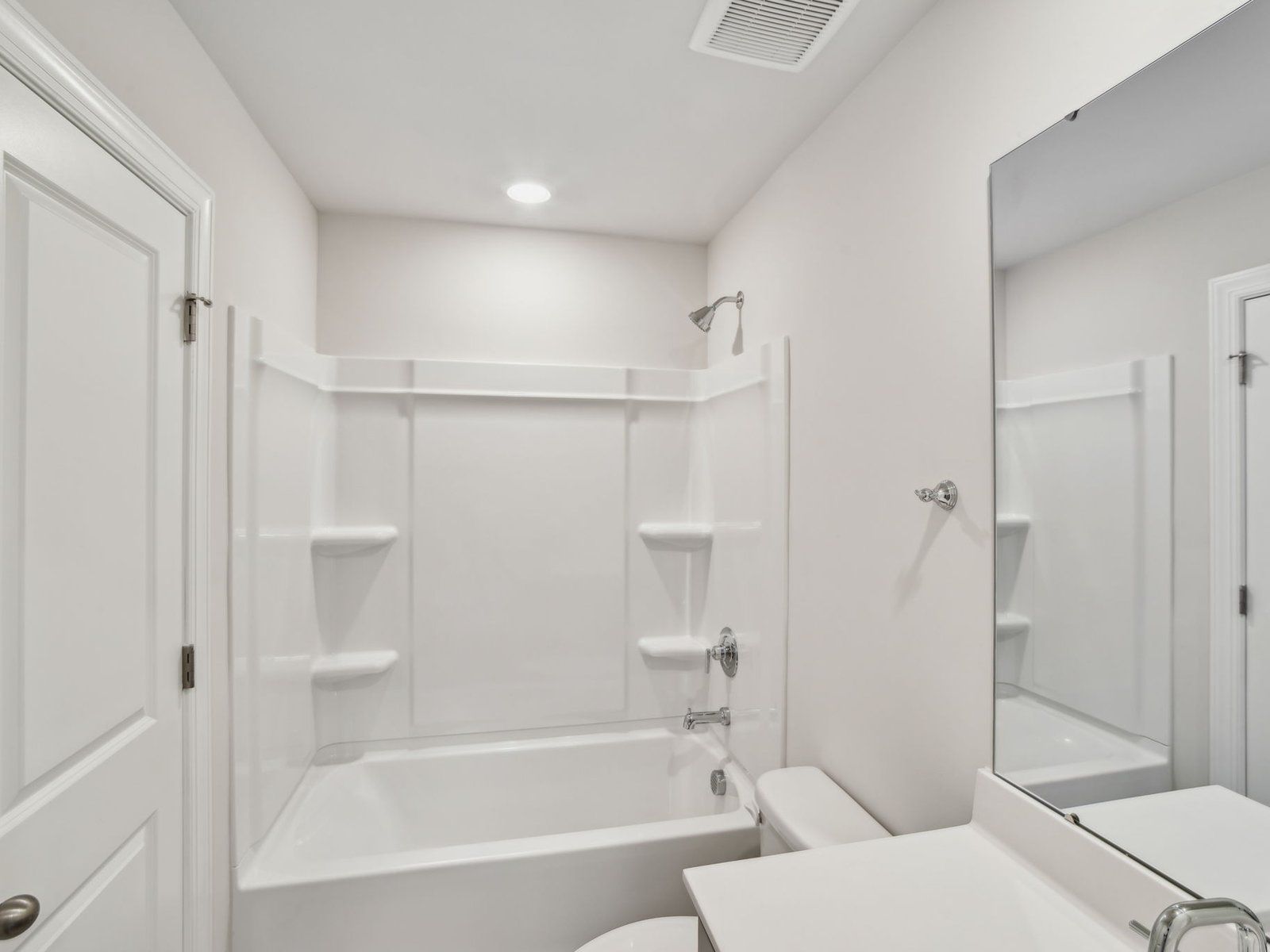 The secondary bathroom boasts an oversized tub and modern vanity.